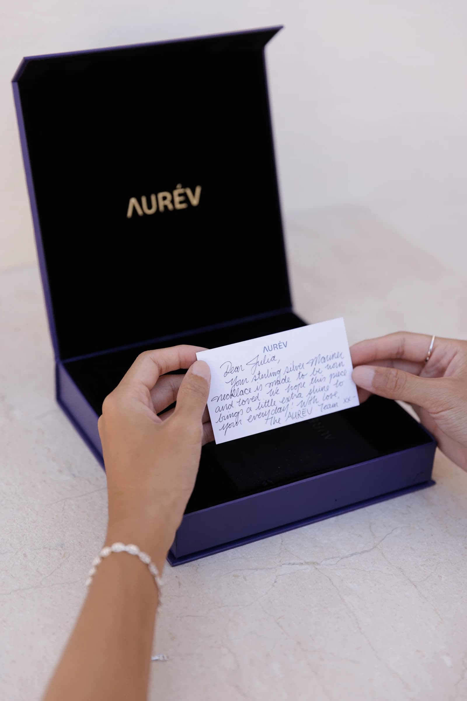 Handwritten note inside an AURÉV gift box